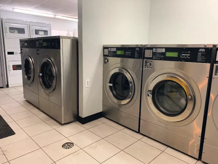 Front-load washers and stacked dryers inside the Neville's laundromat